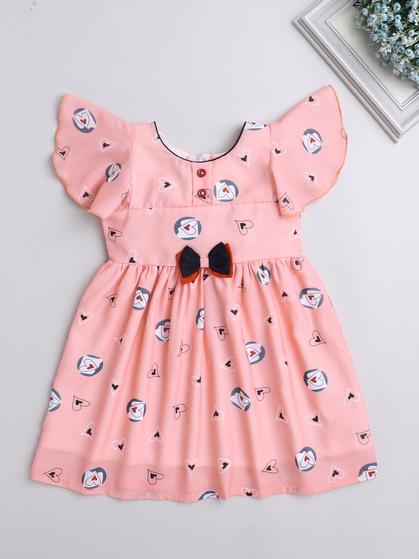 Heart Printed Flutter Sleeve Dress With Bow For Girls-Peach