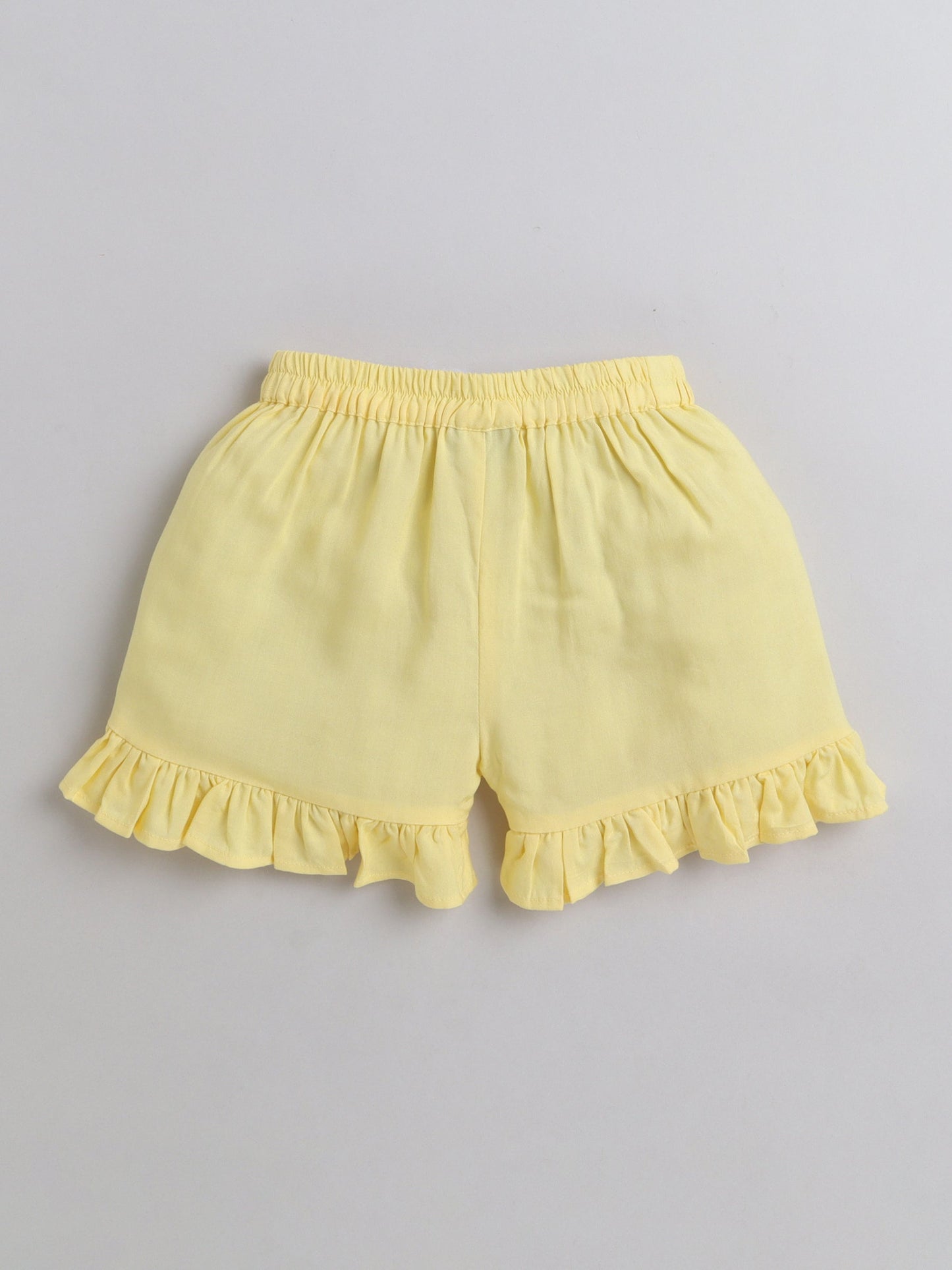 The Magic Wand Rayon Ruffled Sleeveless Solid Tassels Embelished Top With Shorts Yellow
