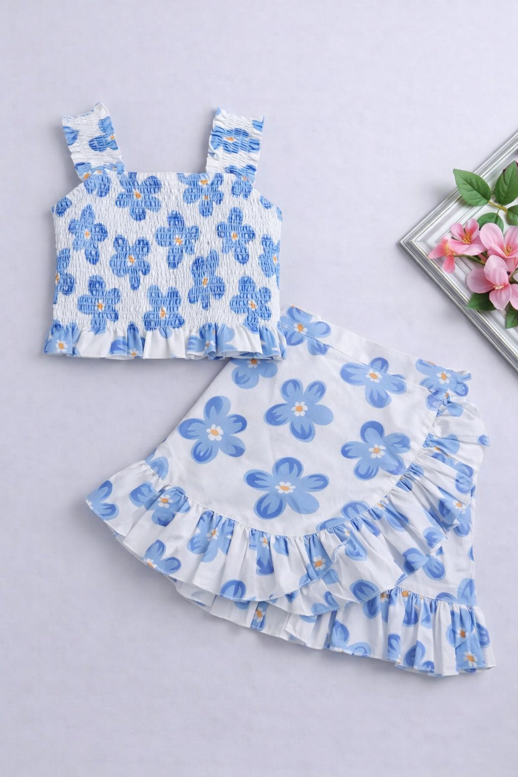 The Magic Wand Cotton Woven Sleeveless Floral Printed Smocked Top And Wrap Frill Skirt - Blue