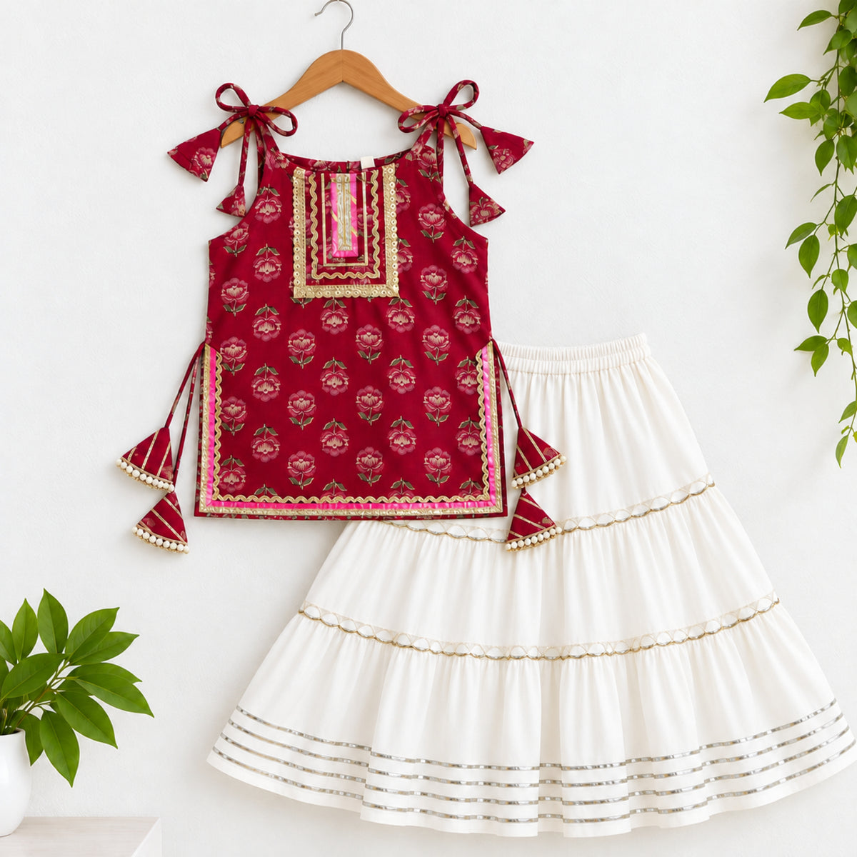 The Magic Wand Cotton Woven Cambric Floral Printed Laced And Tassel Detail Shoulder Tie-Up Kurti And Rayon Skirt Set - Magenta
