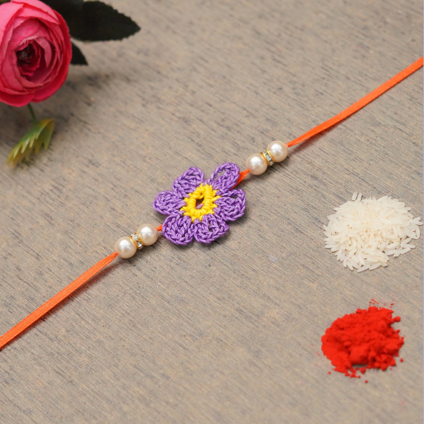 The Magic Wand Cute Flower Applique Pearl Detailing Handmade Crochet Rakhi For Kids-Purple