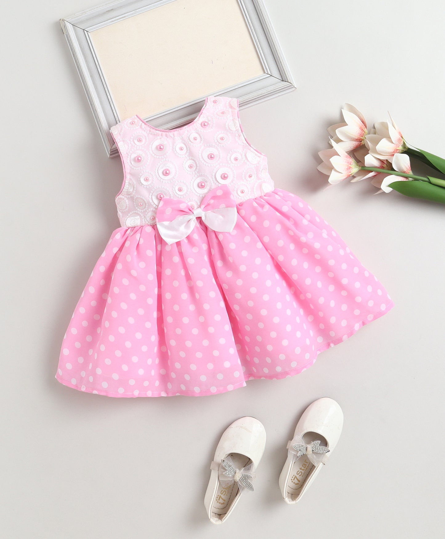 The Magic Wand Woven Sleeveless Polka Dot Pearl Embellished Flared Dress With Bow Applique - Pink