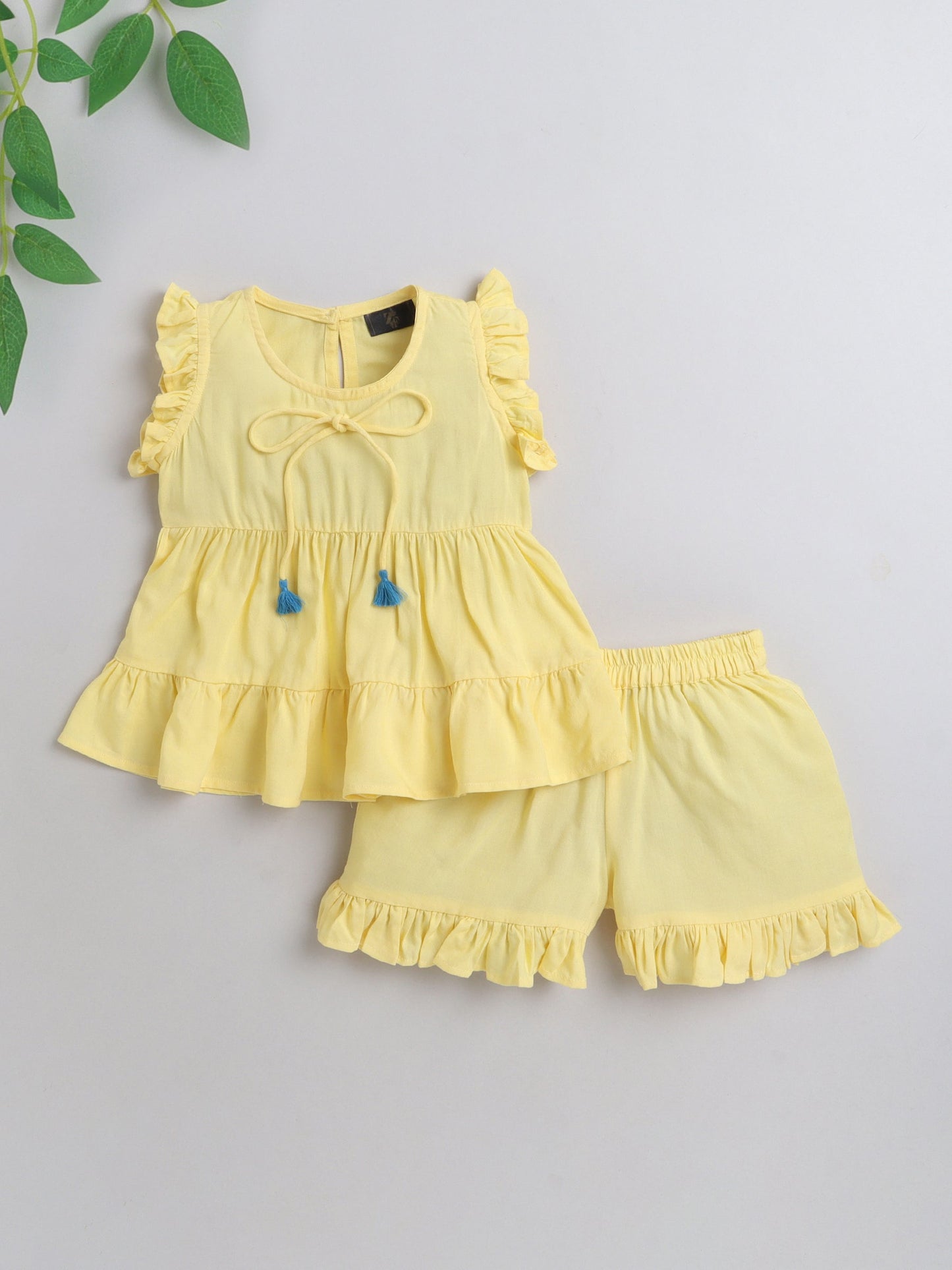 The Magic Wand Rayon Ruffled Sleeveless Solid Tassels Embelished Top With Shorts Yellow